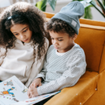 two young children reading a decodable book for beginners