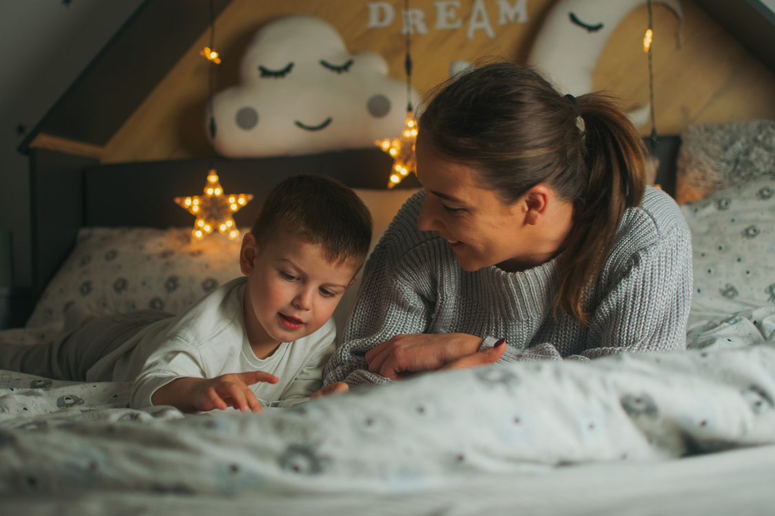 woman and her child reading a bedtime story